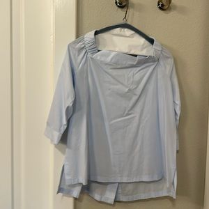 Light blue top with buttons in the back
